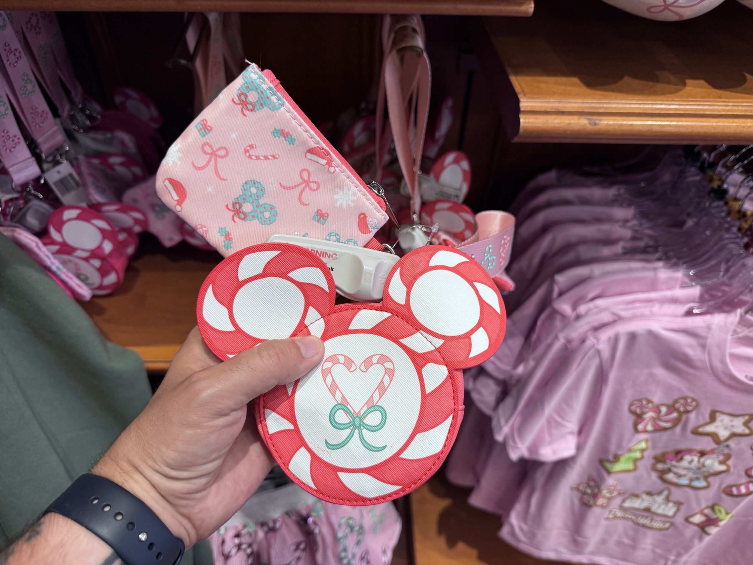 Peppermint-striped Mickey head pouch with a candy cane heart and a printed zip pouch on a pink lanyard