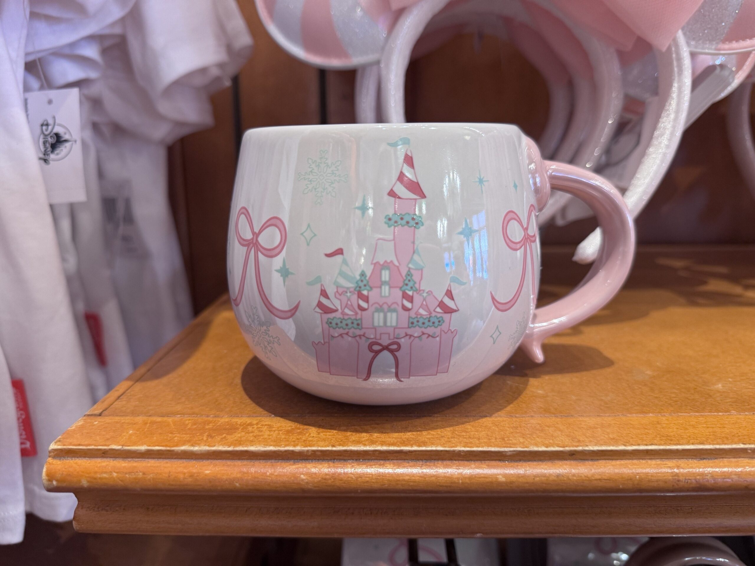 Iridescent white mug with a pink candy-striped Sleeping Beauty Castle, pink bows and a pink handle