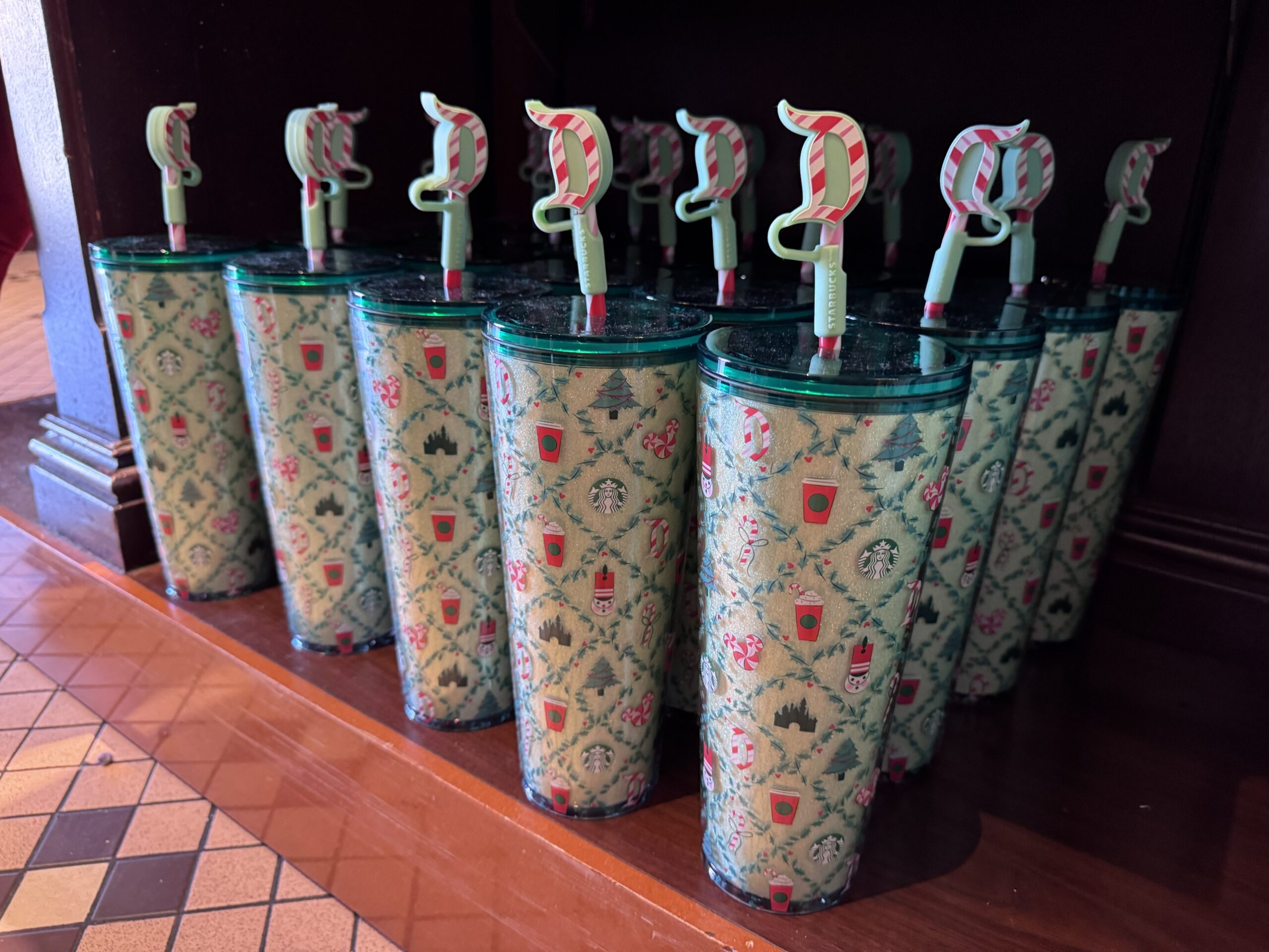 Mint green glitter Starbucks acrylic tumblers with holiday pattern and candy cane Disneyland D straw toppers