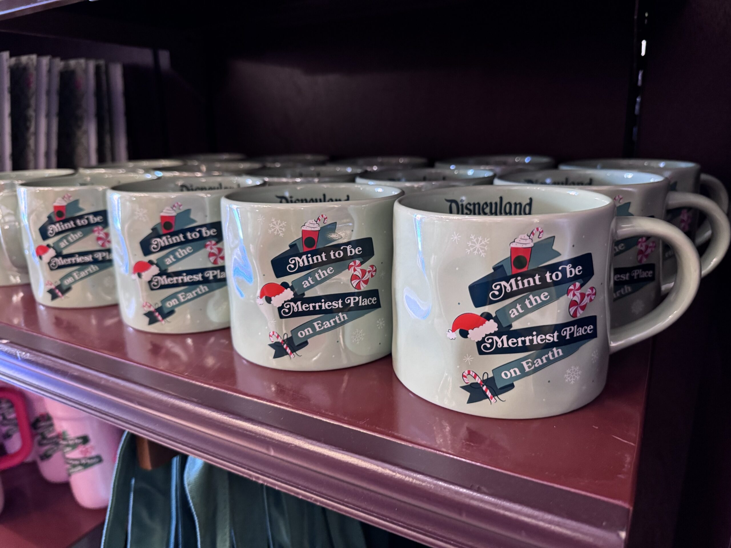 Mint green Starbucks mugs reading Mint to be at the Merriest Place on Earth with Disneyland printed inside the rim