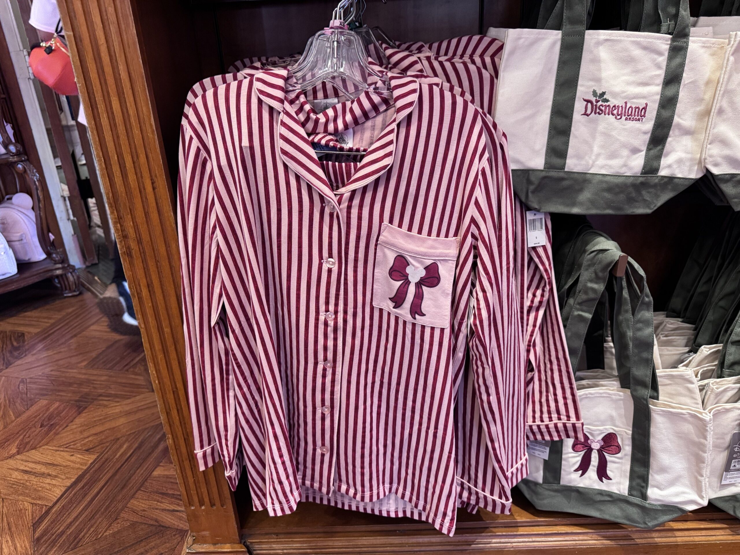 Burgundy and pink striped button-up pajama top with a bow and Mickey icon on the pocket