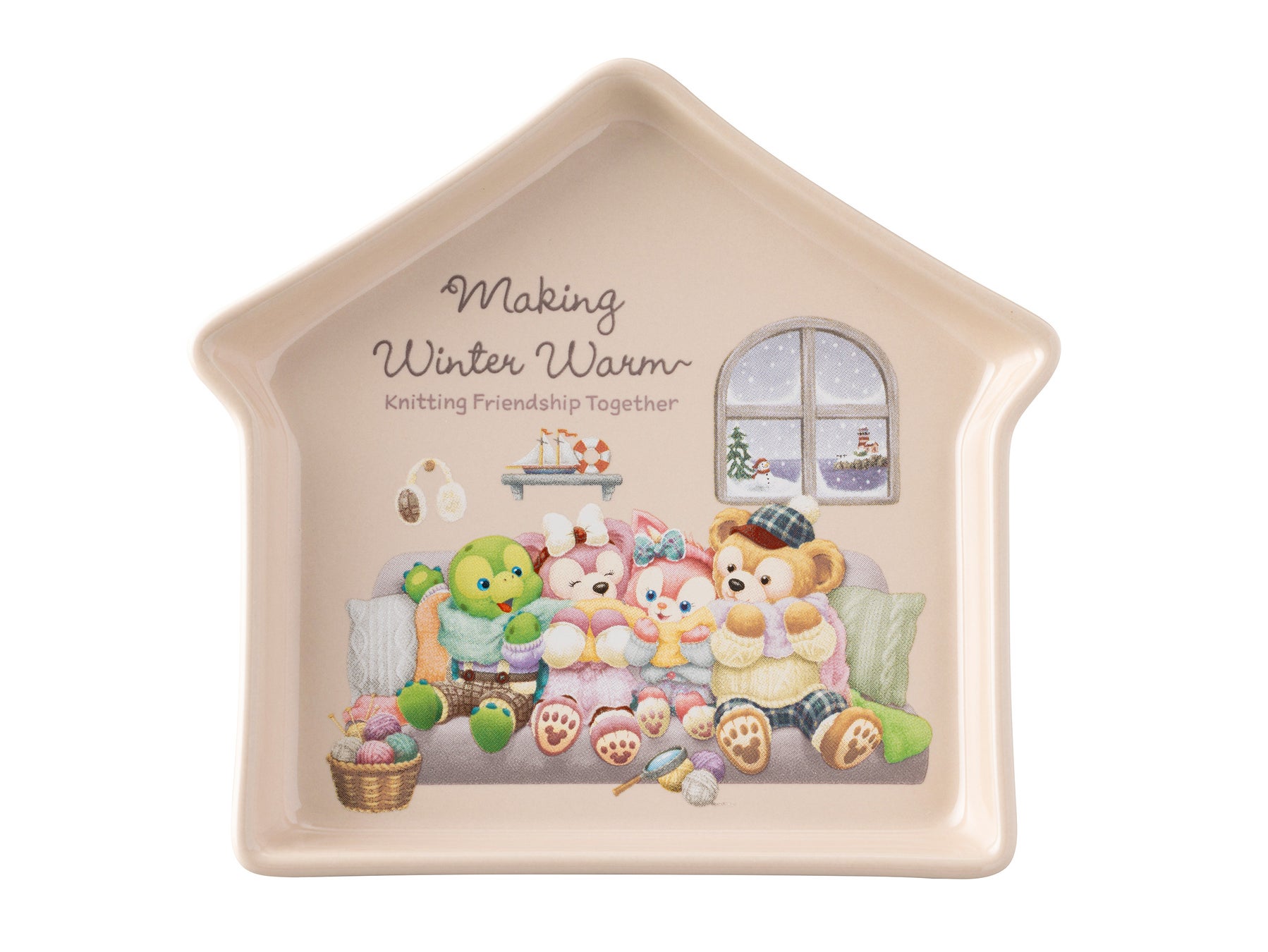 House-shaped Making Winter Warm souvenir plate showing Duffy and Friends knitting on a sofa