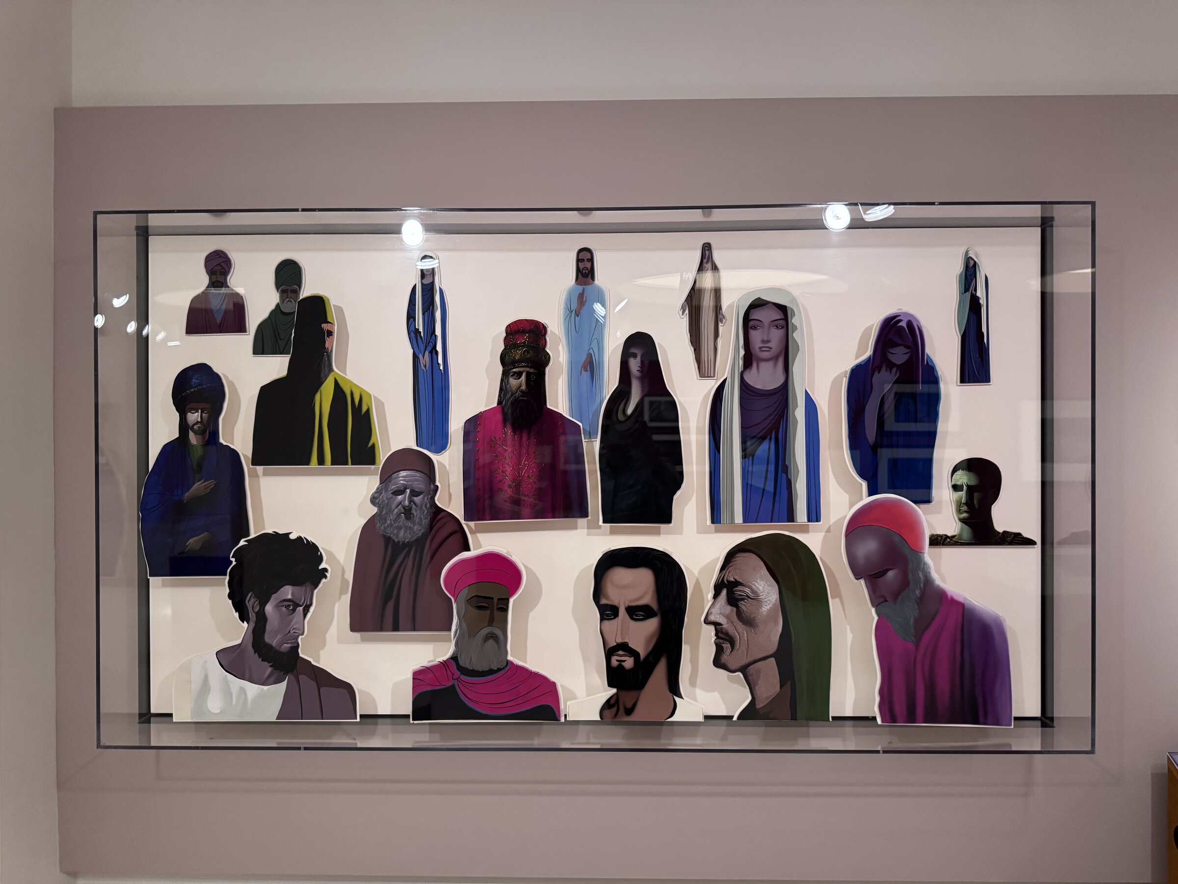 Eyvind Earle's painted character animation cutouts of biblical figures for the unreleased The Story of Easter, displayed in a glass case