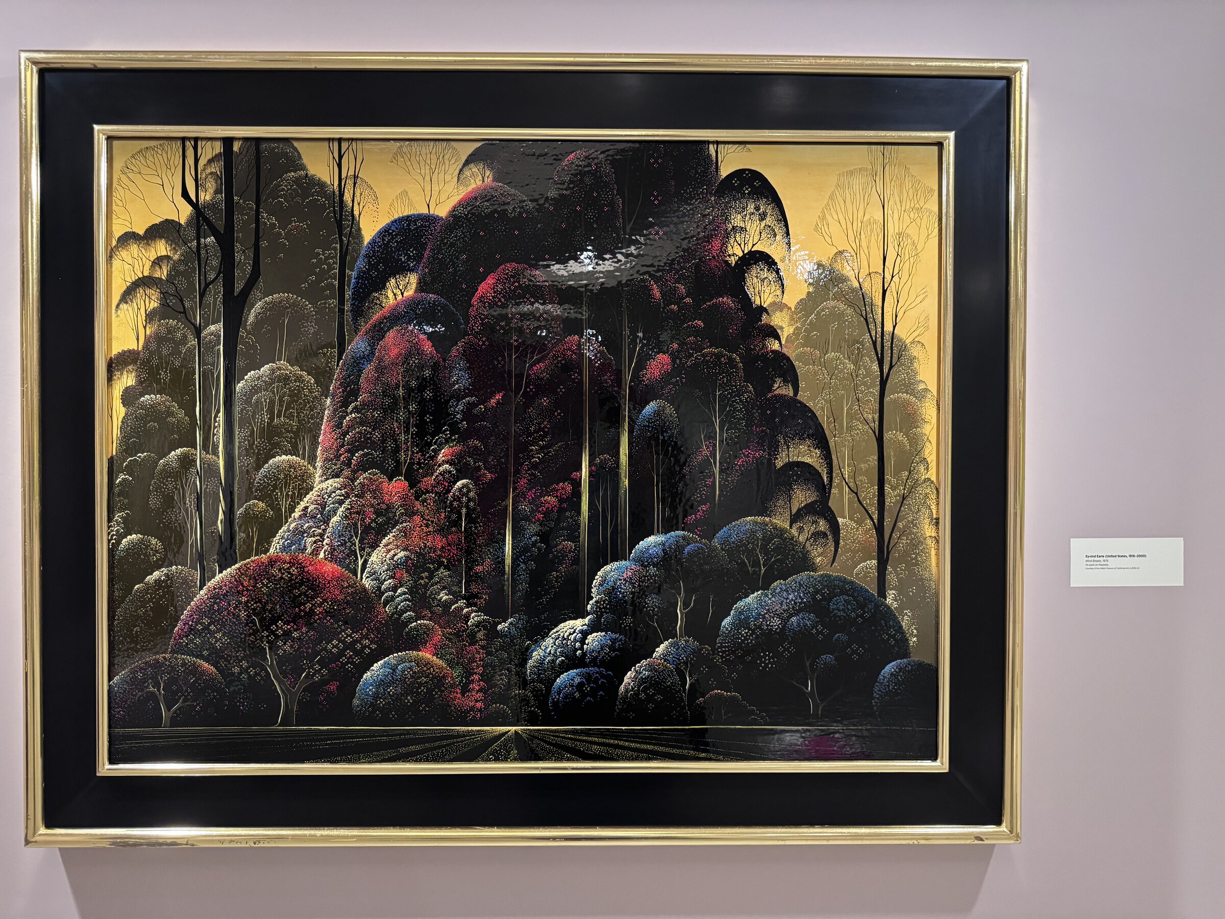 Eyvind Earle's Wind Breaks, a 1979 oil painting of dense red and dark trees against a golden sky