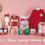 Products from Hallmark's Holiday Ever After collection with Disney, including Minnie ears, a Loungefly backpack, Mickey and Minnie plush, a tumbler, a mug, cards, gift bags, a red sweatshirt and pajamas