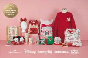 Products from Hallmark's Holiday Ever After collection with Disney, including Minnie ears, a Loungefly backpack, Mickey and Minnie plush, a tumbler, a mug, cards, gift bags, a red sweatshirt and pajamas