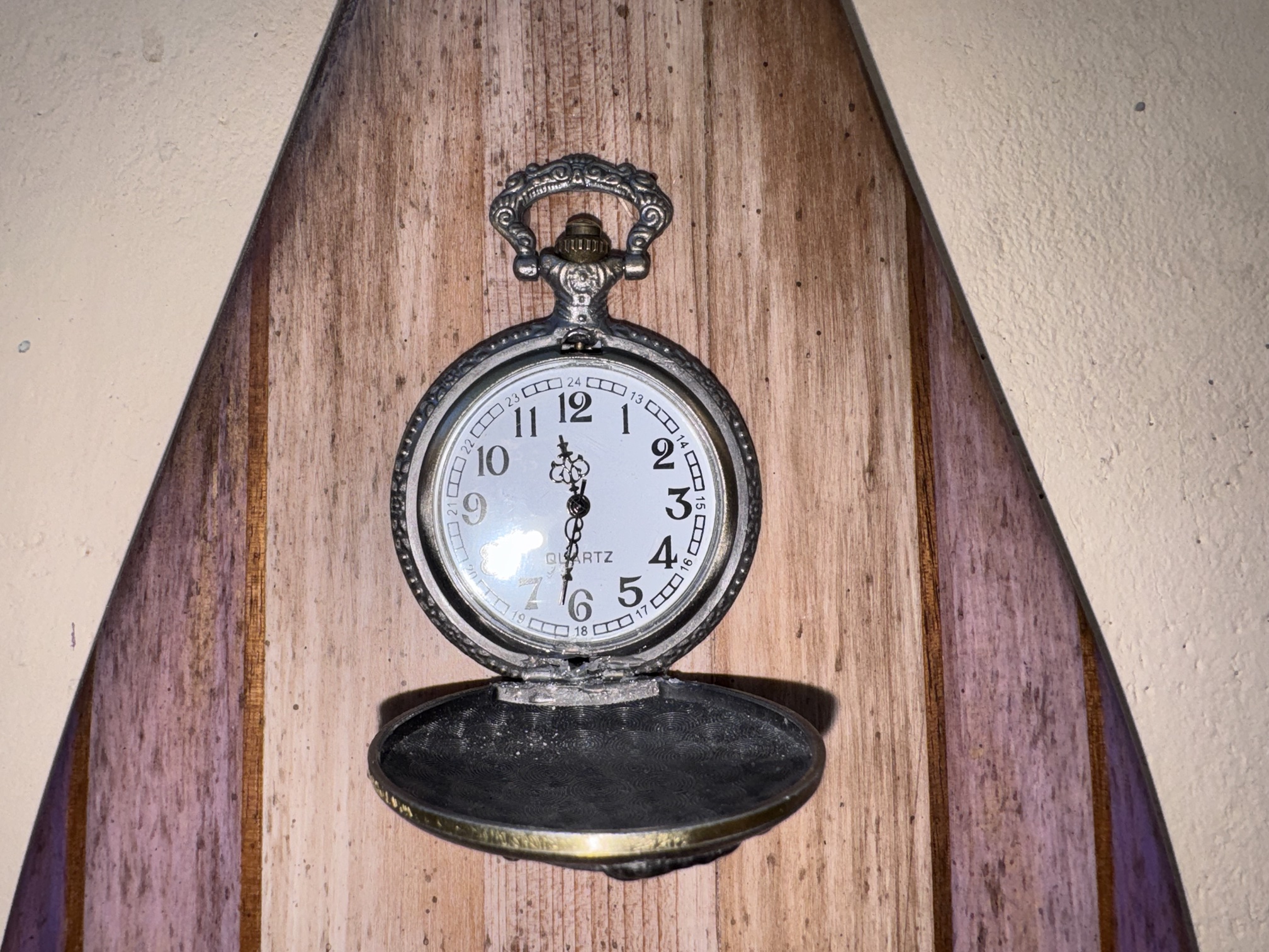 Open pocket watch mounted on Hazel Hightower's oar