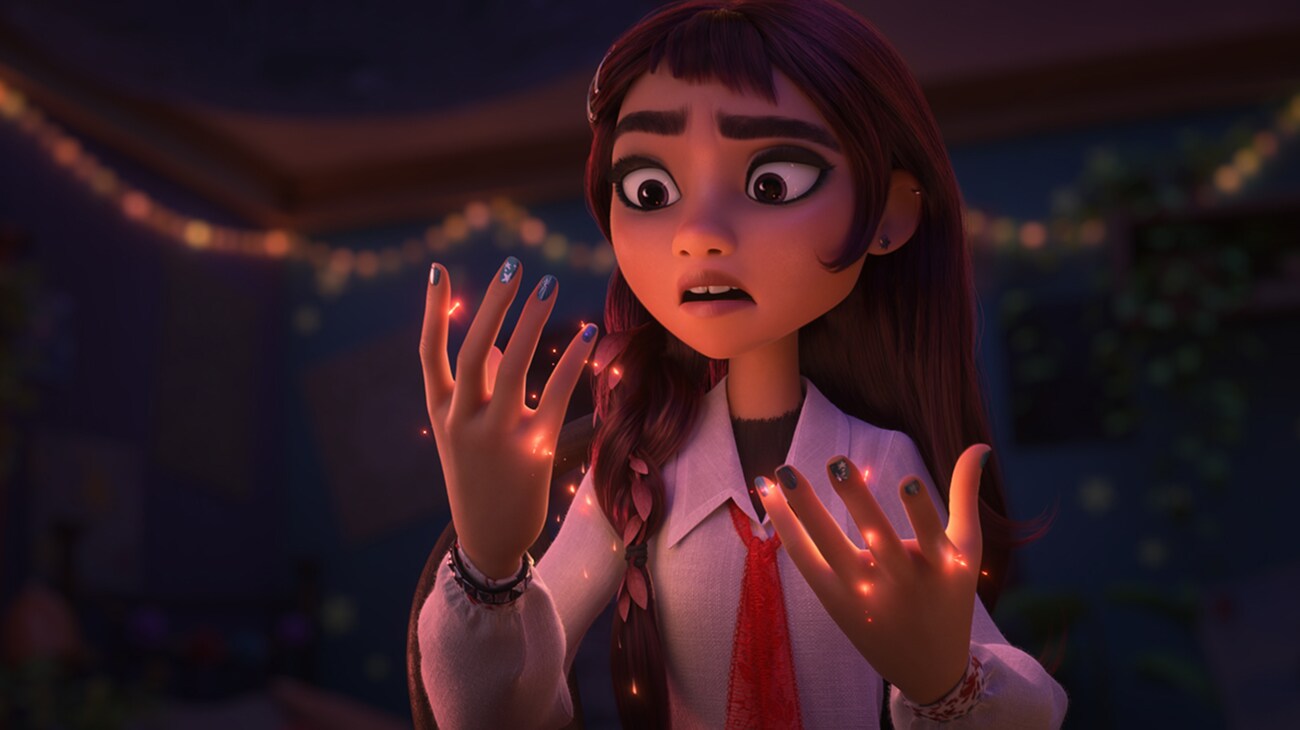 Billie looks at glowing sparks on her hands in a still from Walt Disney Animation Studios' Hexed