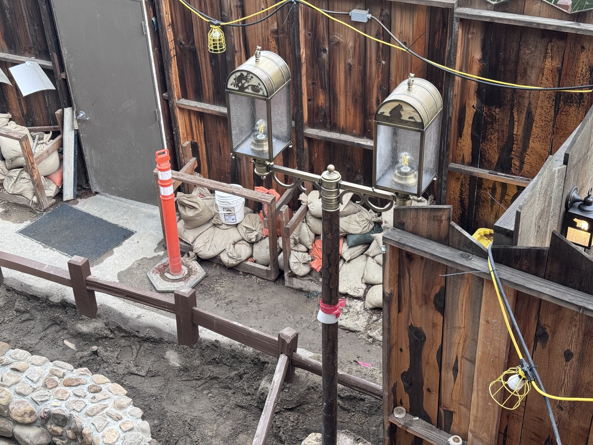 A double-headed lantern post in the downstairs seating construction area at Hungry Bear Barbecue Jamboree