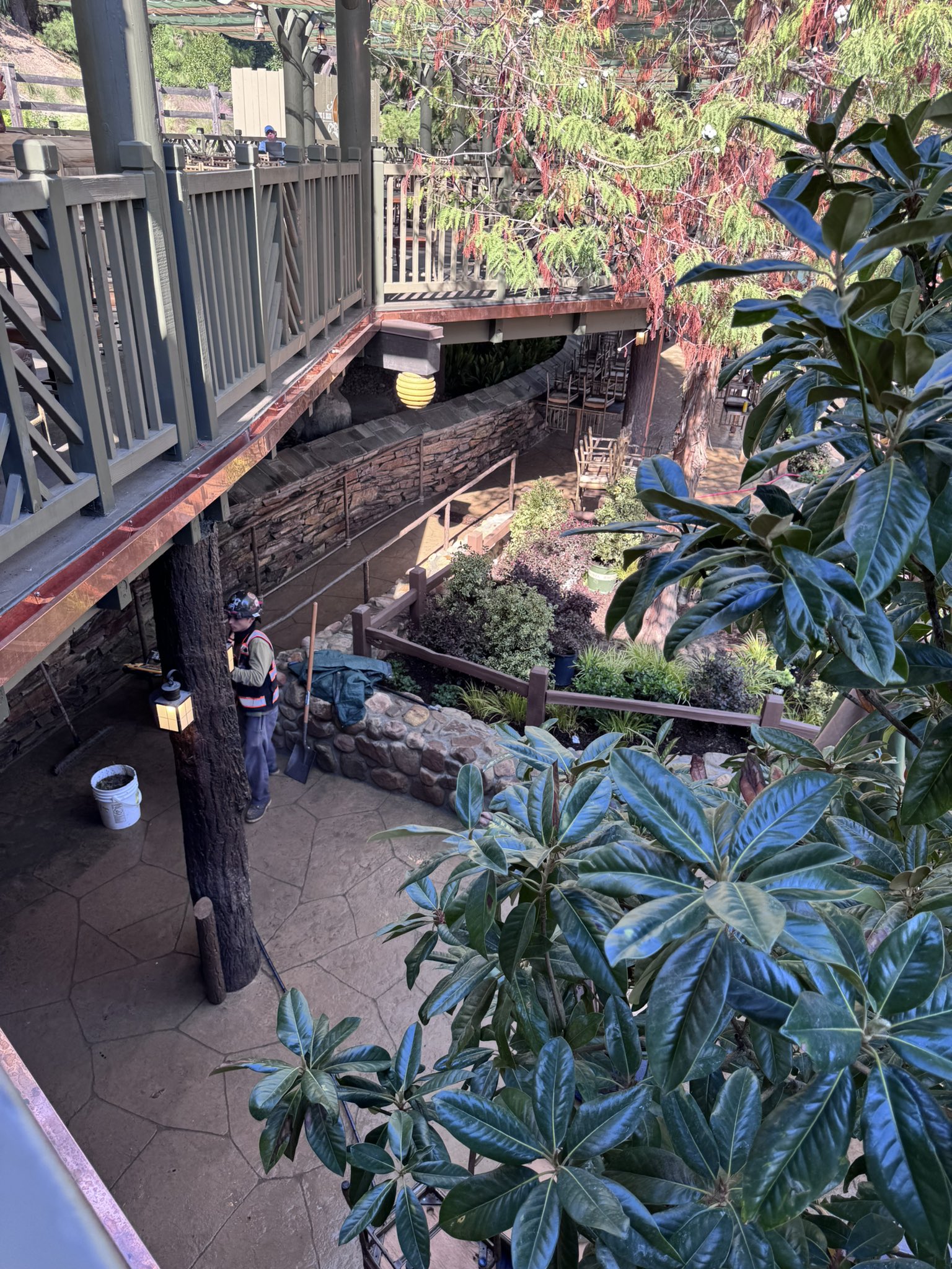 The walkway beneath the Hungry Bear Barbecue Jamboree deck with new planters and a stone wall