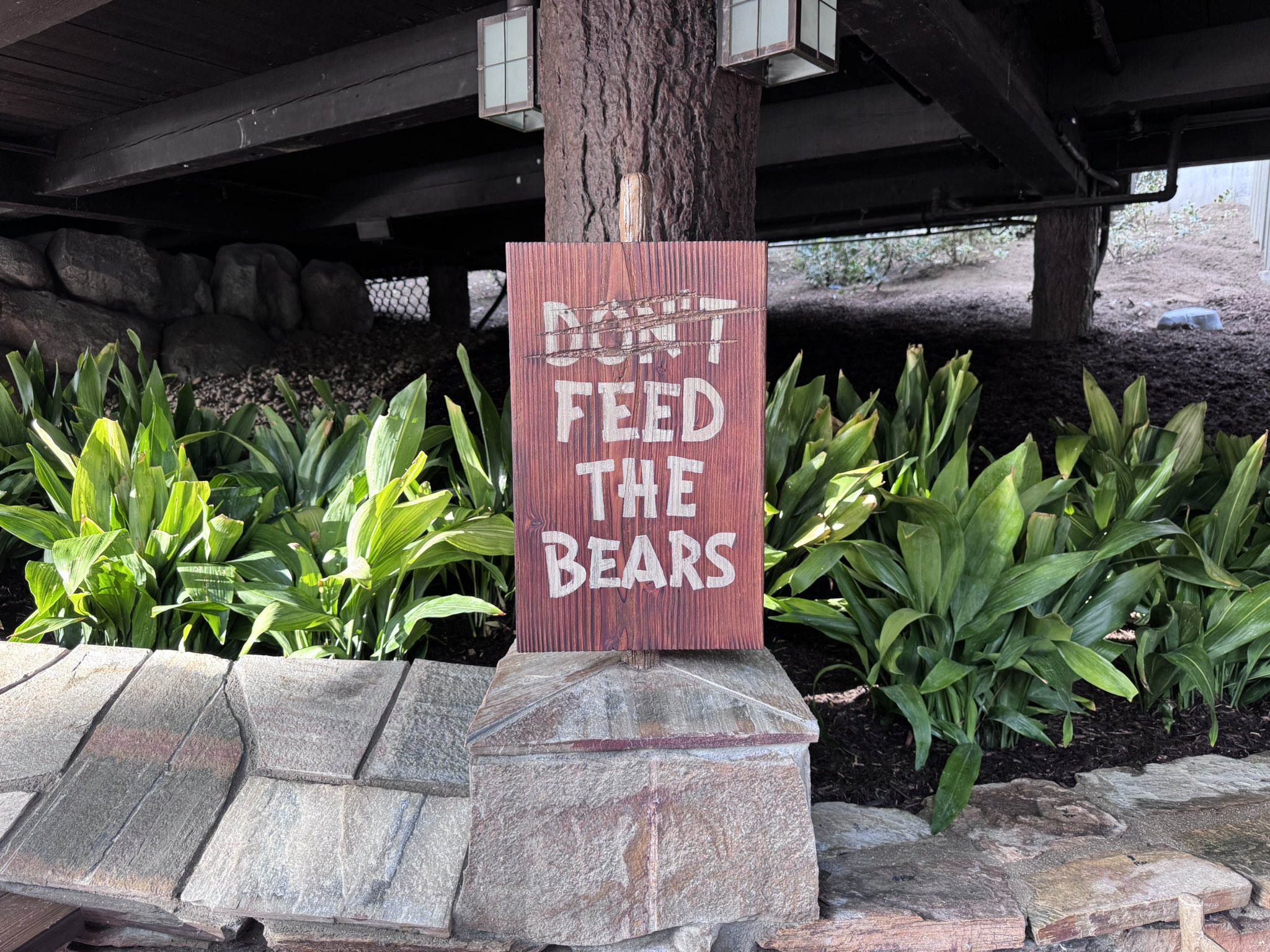 A sign with Don't crossed out so it reads Feed The Bears at Hungry Bear Barbecue Jamboree in Disneyland