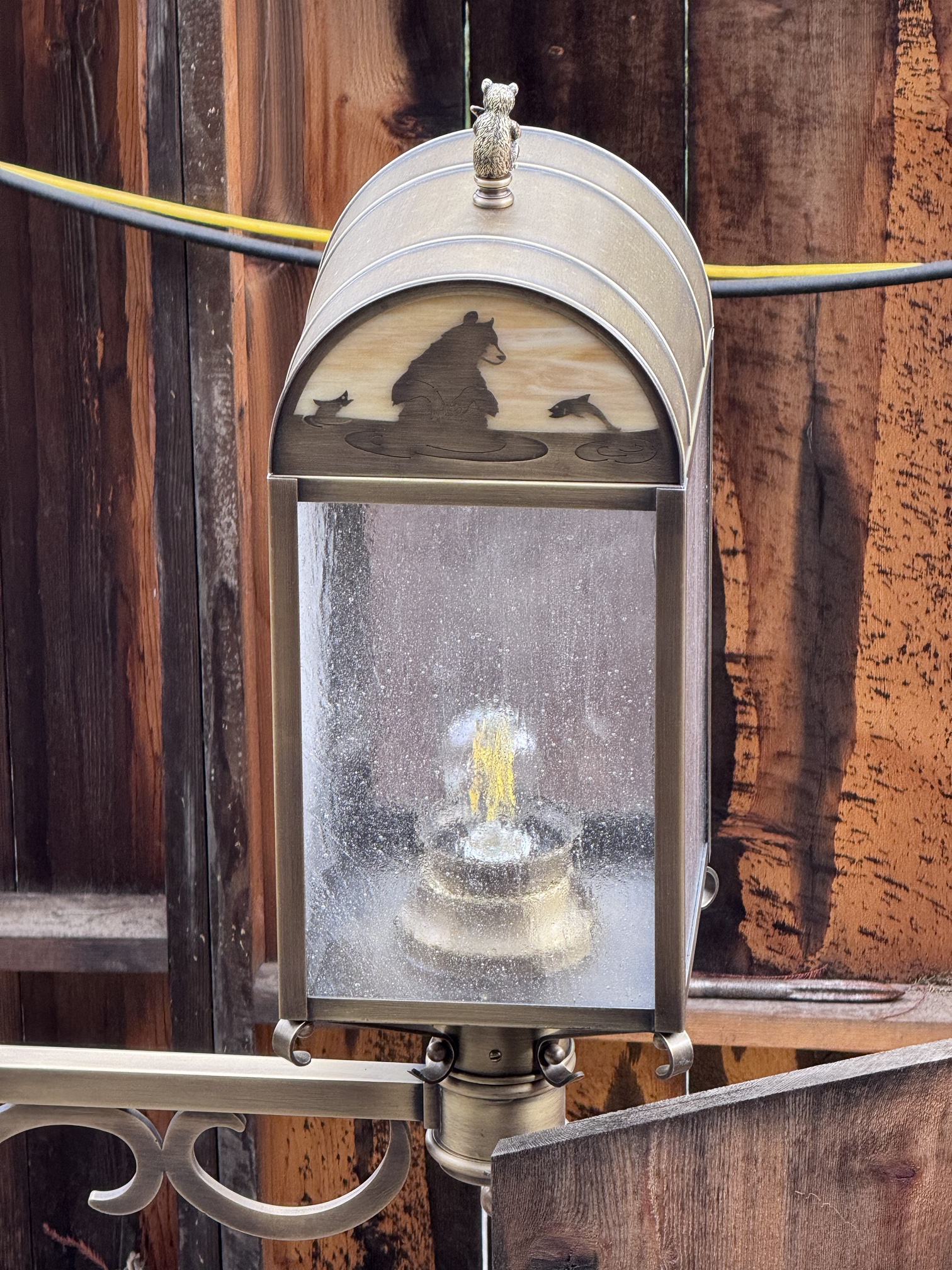 A Hungry Bear Barbecue Jamboree lantern with a bear sitting in water as fish leap around it