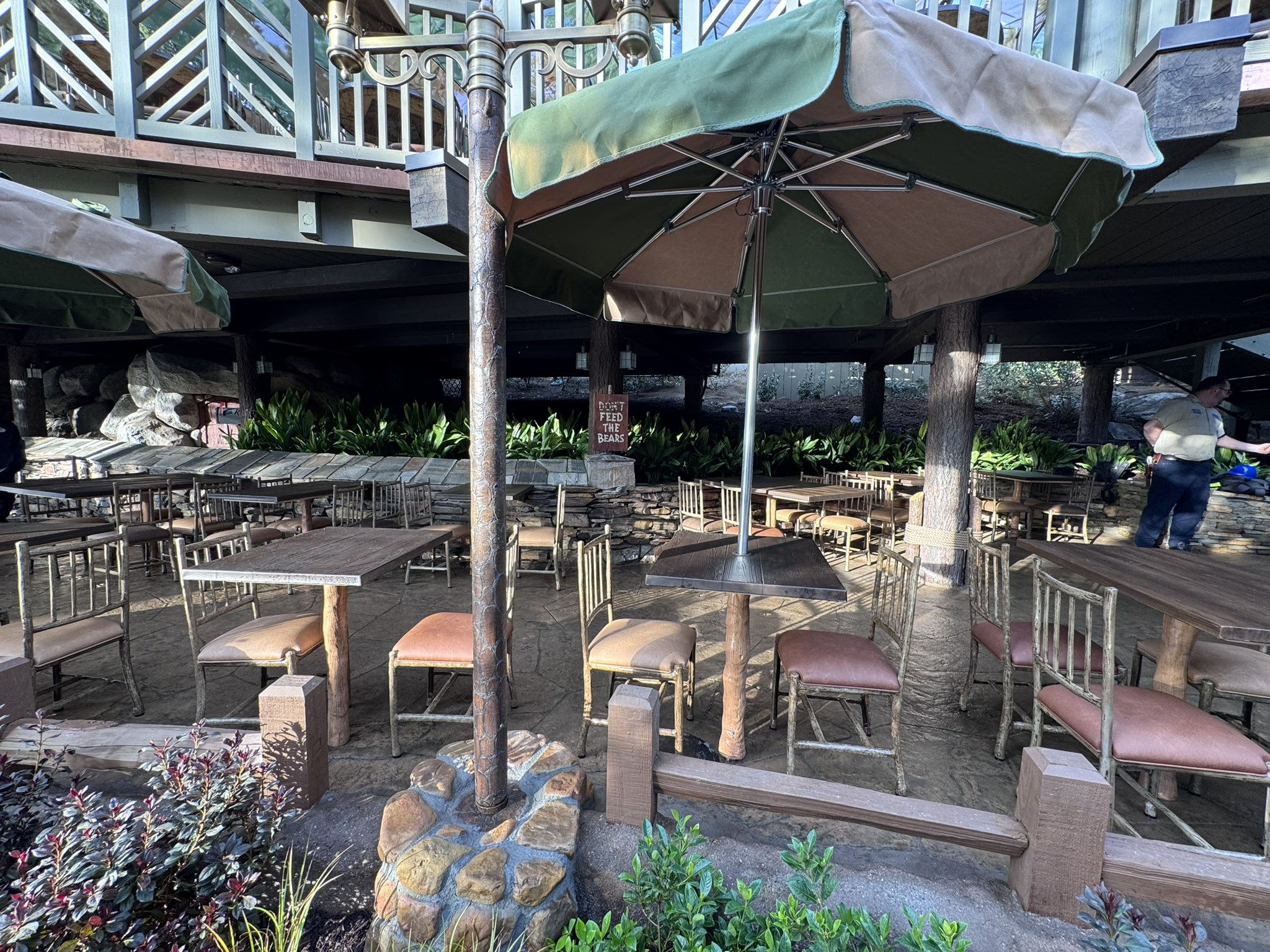 Tables, umbrellas and a Feed The Bears sign in the new lower seating area at Hungry Bear Barbecue Jamboree