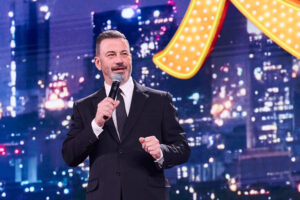 Jimmy Kimmel speaking on stage with a microphone at Disney's 2026 Upfront
