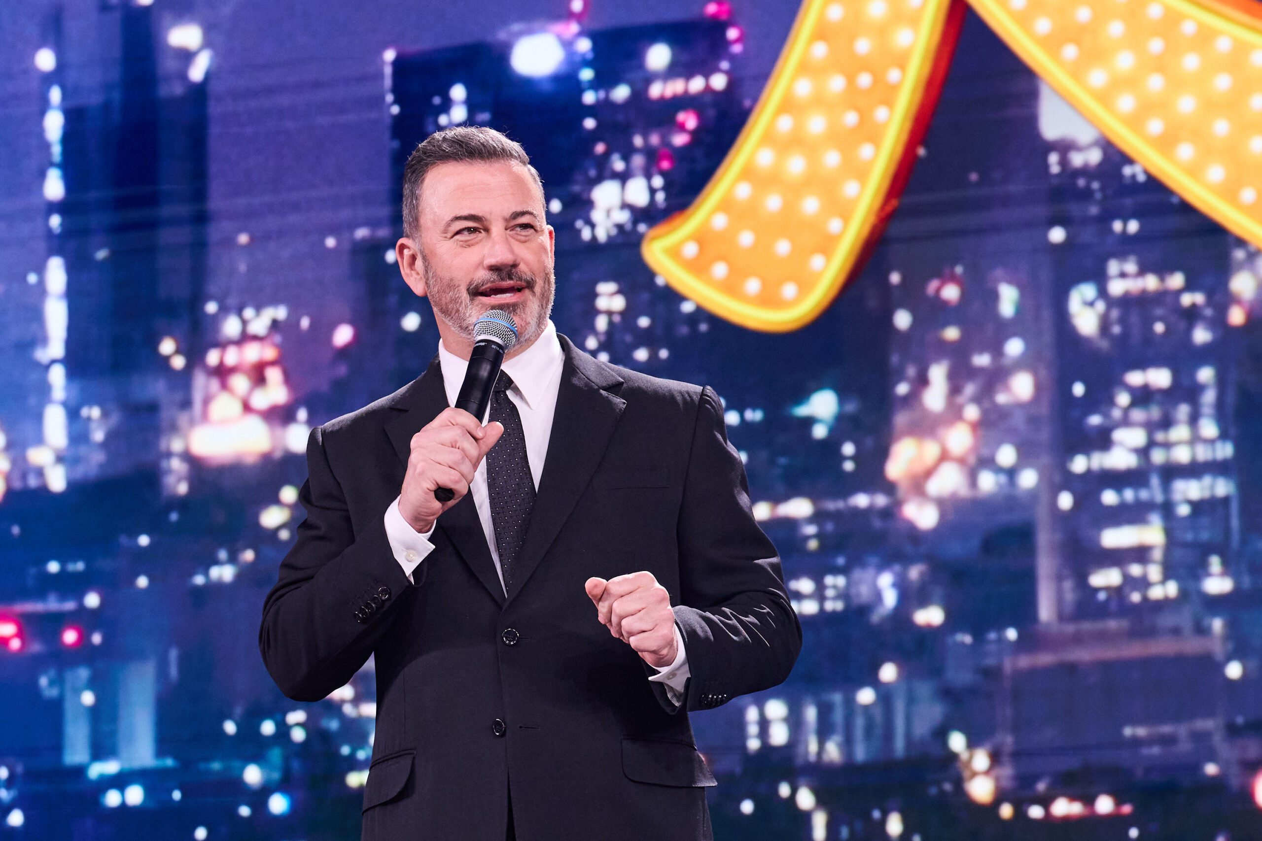 Jimmy Kimmel speaking on stage with a microphone at Disney's 2026 Upfront