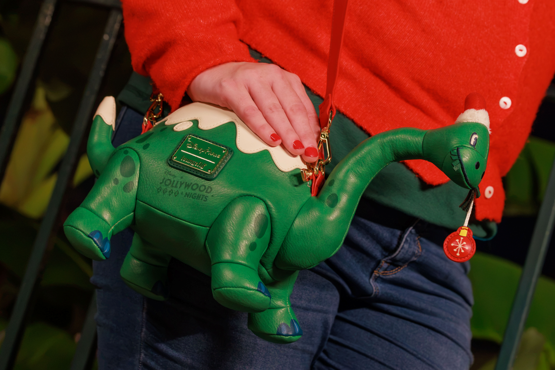 Gertie Jollywood Nights Loungefly bag shaped like the green dinosaur with snow on her back