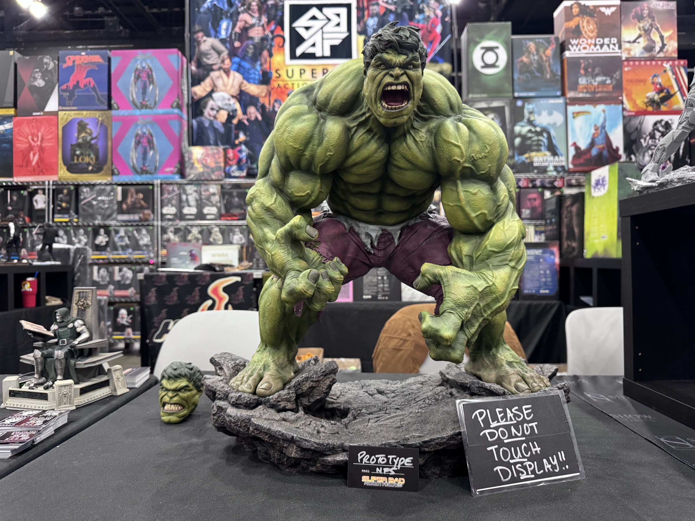 A roaring Hulk statue prototype marked not for sale with a Please Do Not Touch Display sign