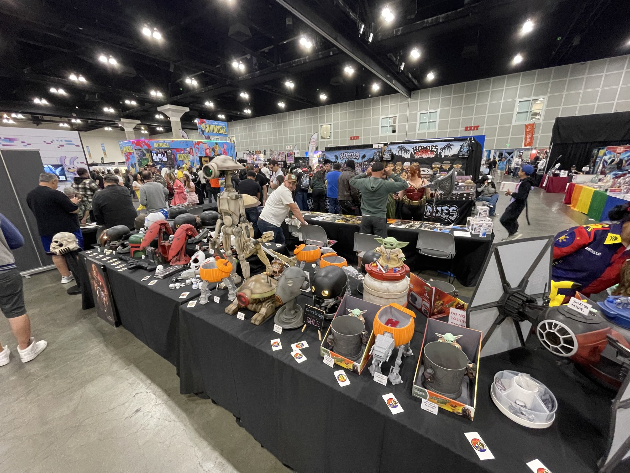 TD Outpost's table of 3D-printed Star Wars pieces including a pit droid, pumpkin-topped AT-AT walkers, Grogu figures and a TIE fighter
