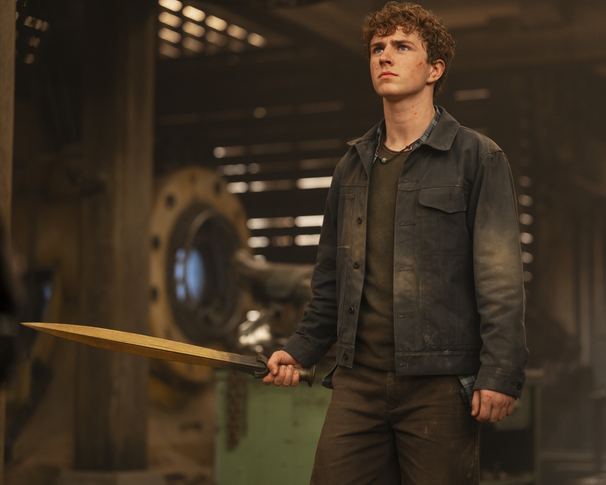 Walker Scobell as Percy Jackson holding Riptide in Percy Jackson and the Olympians Season 3