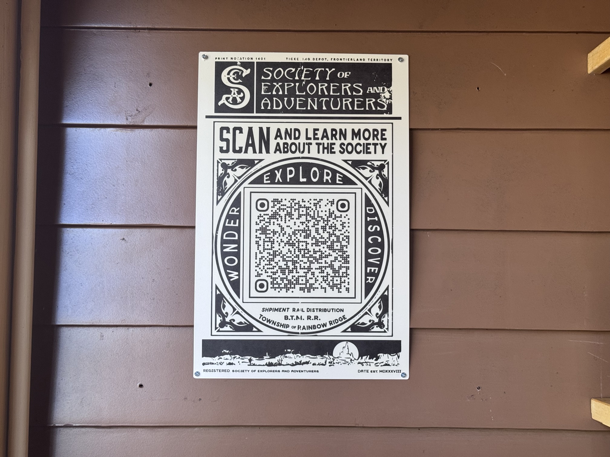 Society of Explorers and Adventurers sign with a QR code reading Scan and learn more about the Society