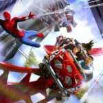 Rendering of riders on Shanghai Disneyland's Spider-Man coaster with Spider-Man swinging alongside the train past city buildings