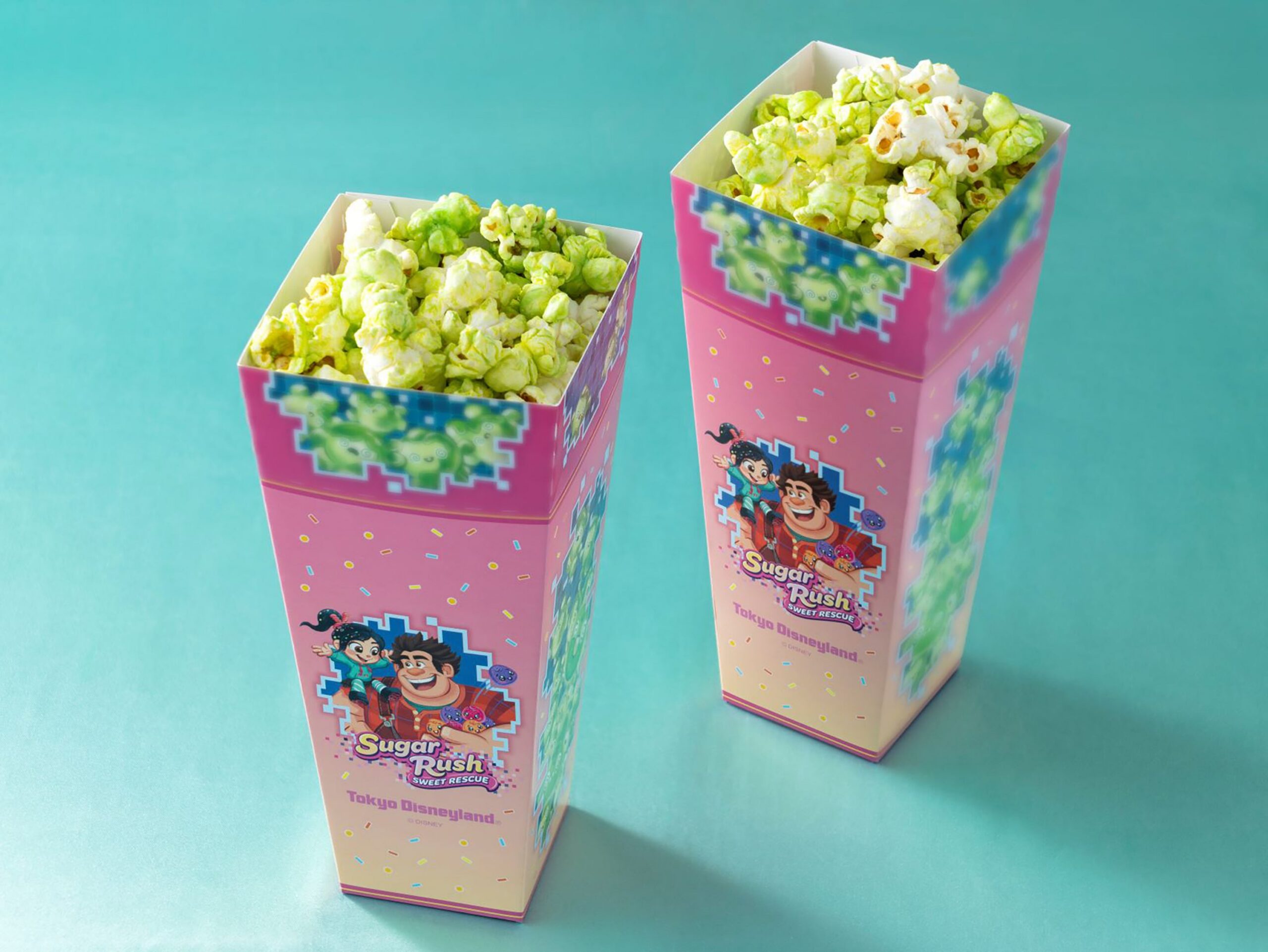 Two boxes of green Sugar Lime Popcorn in pink Sugar Rush: Sweet Rescue packaging