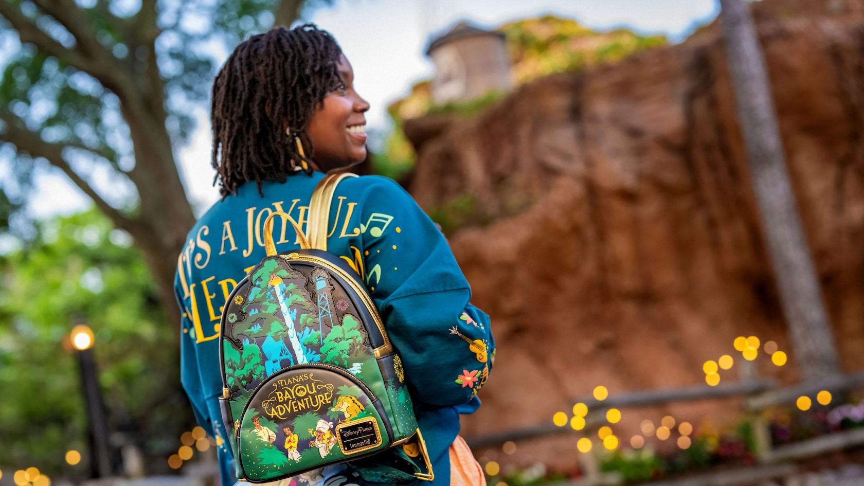 A guest in front of Tiana's Bayou Adventure at Magic Kingdom