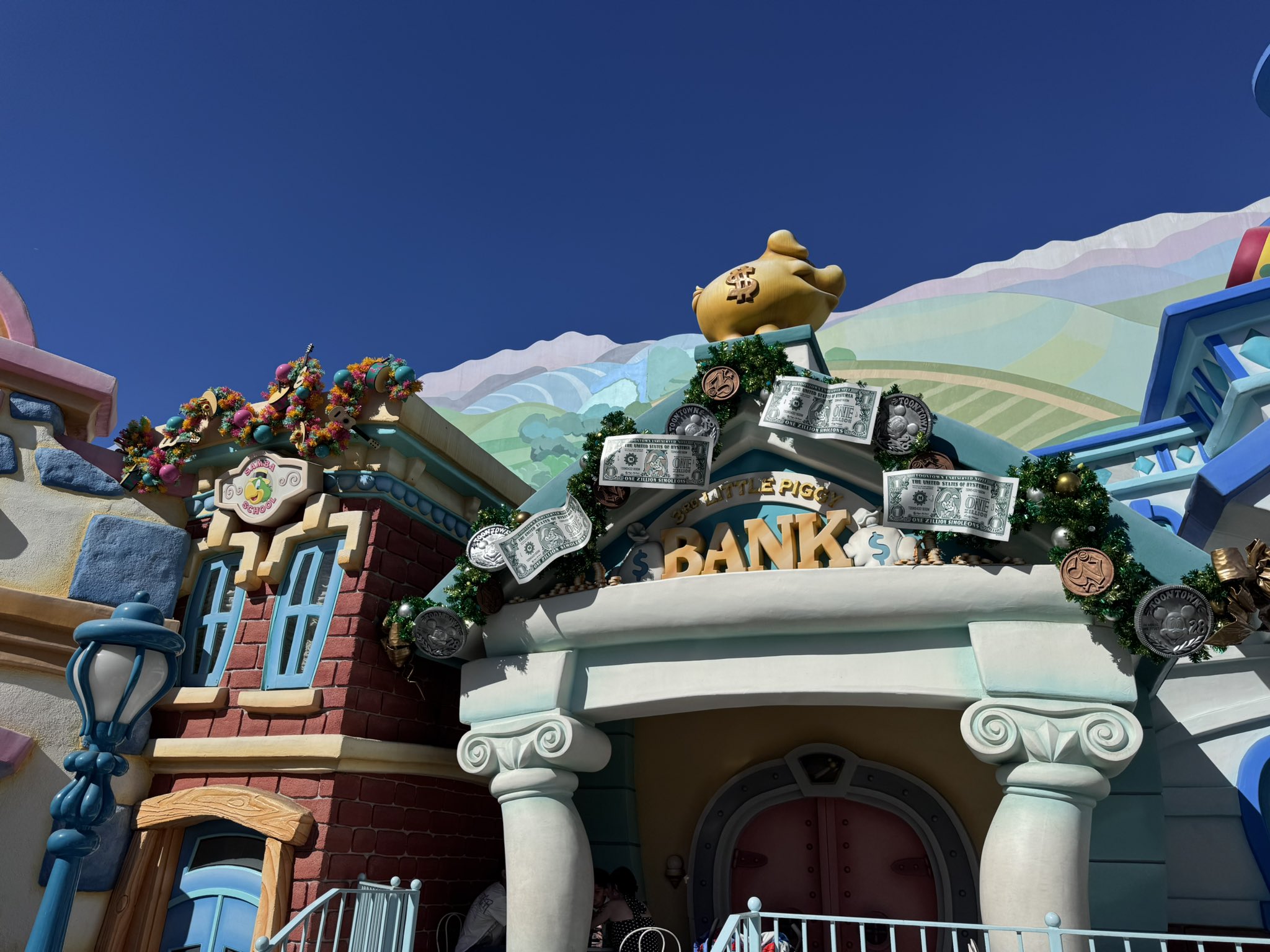 Christmas garland with dollar bills and coins on the bank in Mickey's Toontown at Disneyland