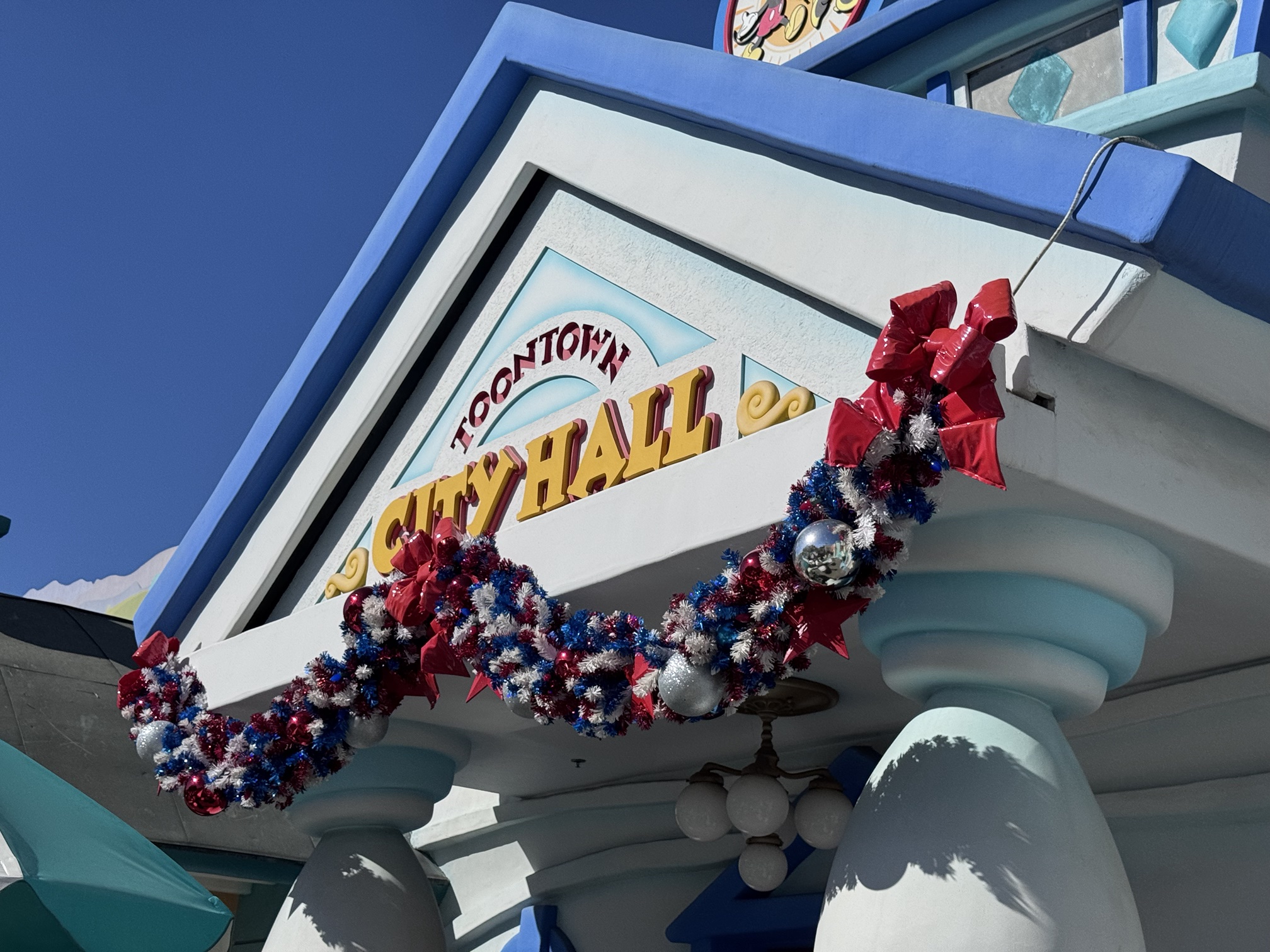 Red, white and blue garland on Toontown City Hall at Disneyland
