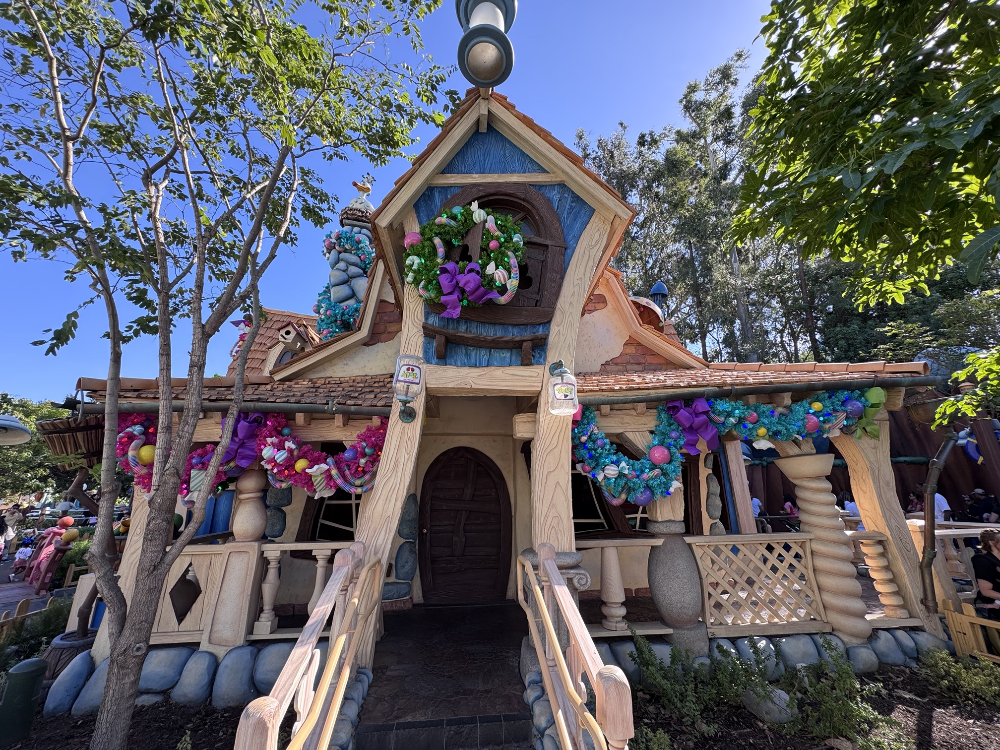 Candy-themed Christmas wreath and garland on the front of Goofy's house in Toontown at Disneyland