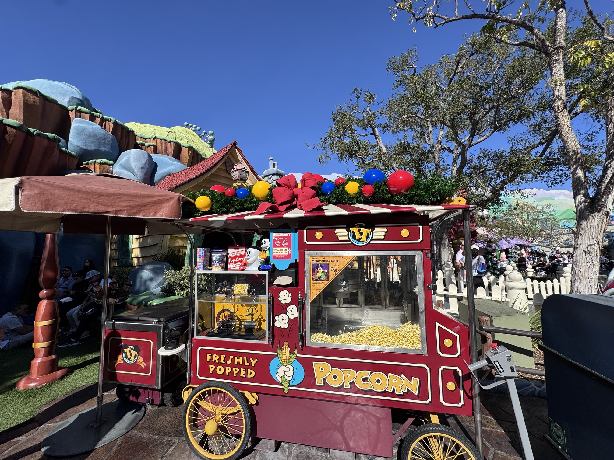 Christmas garland and red bow on the popcorn cart in Mickey's Toontown at Disneyland