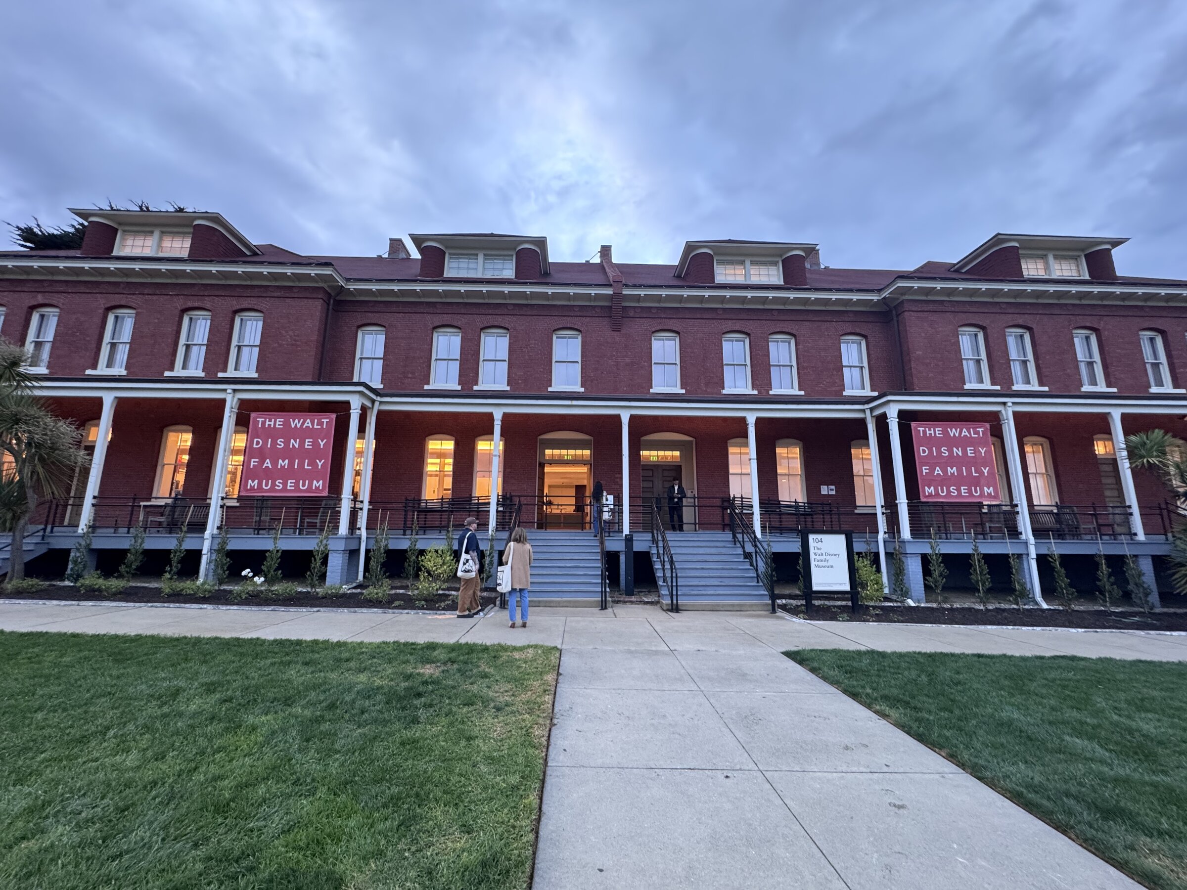 The brick exterior of The Walt Disney Family Museum in the Presidio of San Francisco at dusk